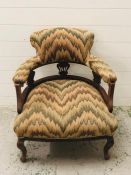 An upholstered open armchair with cabriole legs