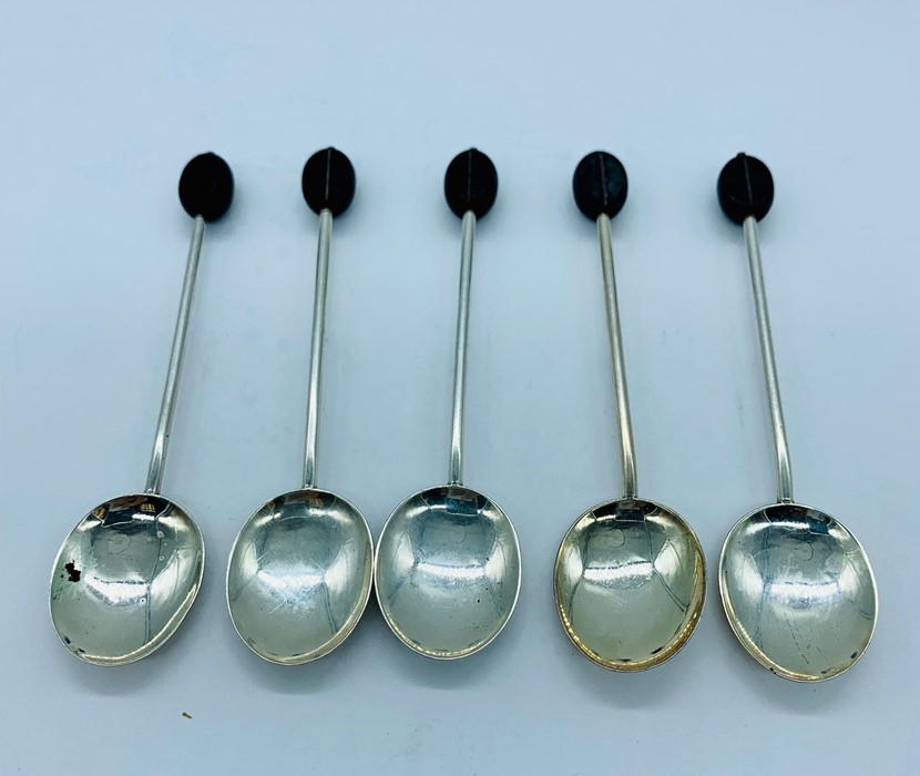 Five silver coffee spoons in the coffee bean style