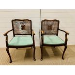 A pair of mahogany chairs with cane backs and green fabric seats (one AF)