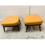 A pair of mid century Ercol footstools