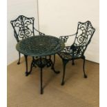 A round metal garden table with two chairs