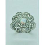 A silver CZ and opal set ring