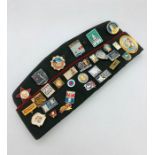 A Russian Military Cap with a wide selection of pins and badges.
