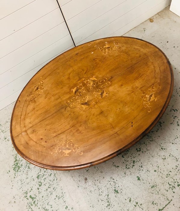 An oval coffee table of Victorian origins with a marquetry inlaid top on a modified base - Image 2 of 3