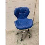 A blue faux leather swivel office style chair