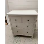 A contemporary two over two white chest of drawers