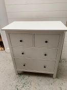 A contemporary two over two white chest of drawers