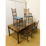 A dining table with six matching chairs (one base missing) bamboo and cane effect frame with cane