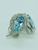 A pair of 18ct white gold pear shaped aquamarine and diamond earrings of 1.78cts