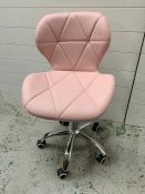 A pink faux leather swivel office style chair