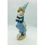 A lladro figure of a clown with a trumpet E-18