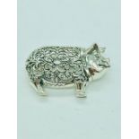 A silver brooch in the form of a pig