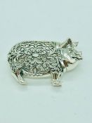 A silver brooch in the form of a pig