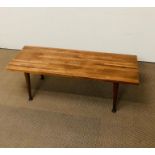 A mid century coffee table with tapered legs