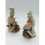 Pair of early Capodimonte candle holders with cherub theme AF