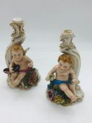 Pair of early Capodimonte candle holders with cherub theme AF