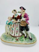 Meissen porcelain figures of a couple and a child with a bird