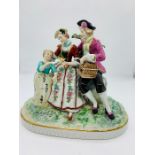 Meissen porcelain figures of a couple and a child with a bird