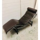 A brown leather contemporary recliner on stand