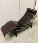 A brown leather contemporary recliner on stand