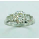 A platinum single stone ring set with a 1.76ct diamond, 3pk j: with two graduated step set