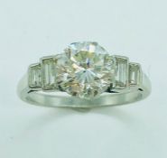 A platinum single stone ring set with a 1.76ct diamond, 3pk j: with two graduated step set
