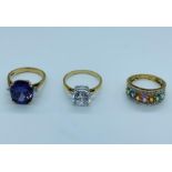 Three 9ct gold rings with a variety of stones and settings.