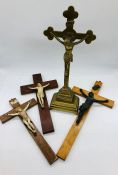 A selection of four crucifixes including one in brass