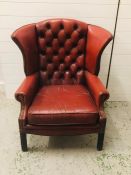 A Red Leather Button Back Armchair