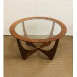 A mid century circular table with glass top