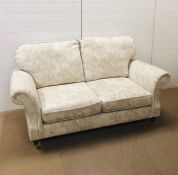A Marks and Spencer "Salisbury AW14" two seater sofa in dioma floral natural fabric with wooden feet