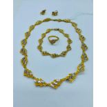 A 9ct yellow gold jewellery set to include necklace, bracelet, earrings and ring. (56.85g)