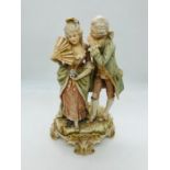 A German Porcelain figure of lady with fan and gentleman whispering 19th Century.