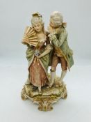 A German Porcelain figure of lady with fan and gentleman whispering 19th Century.