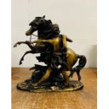 A spelter/bronze figure of a man and horse