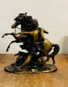 A spelter/bronze figure of a man and horse