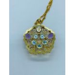 A pendant with semi precious stones to include amethyst, citrine and aquamarine, marked 750 on a