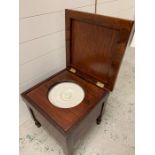 A mahogany commode with original bowl