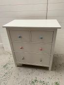 A contemporary two over two white chest of drawers with coloured handles