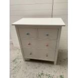 A contemporary two over two white chest of drawers with coloured handles