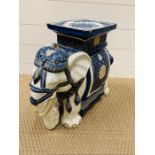 A vintage pottery ceramic elephant plant stand