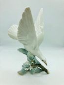 A Lladro figure of a dove on branch