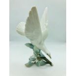 A Lladro figure of a dove on branch