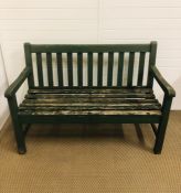 A green painted wooden garden bench