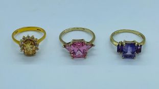 Three 9ct gold rings with a variety of stones to include citrine and amethyst.