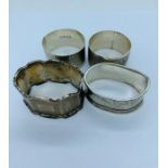 A selection of four various hallmarked silver napkin rings