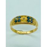 An 18ct yellow gold ring with small Sapphires (2.45g)