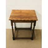 A scalloped edged rectangular side table on barley twist legs