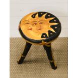 A moon and sun three legged stool