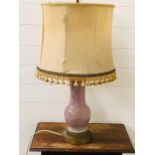 A china and brass based table lamp with fringed shade